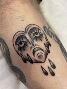 Sad face tattoo