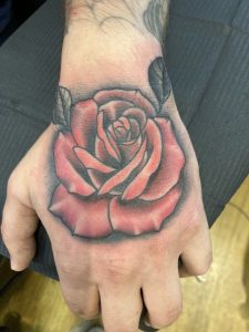 Rose on hand traditional tattoo